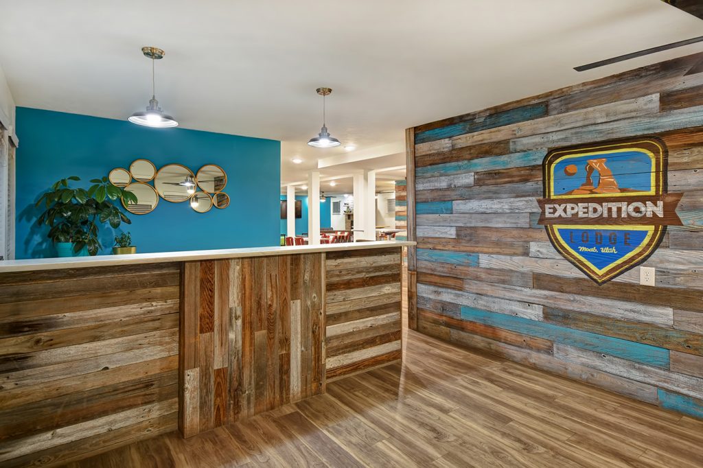 Front desk at Expedition Lodge Moab with a welcoming design and friendly service, providing check-in and guest assistance near Arches National Park.