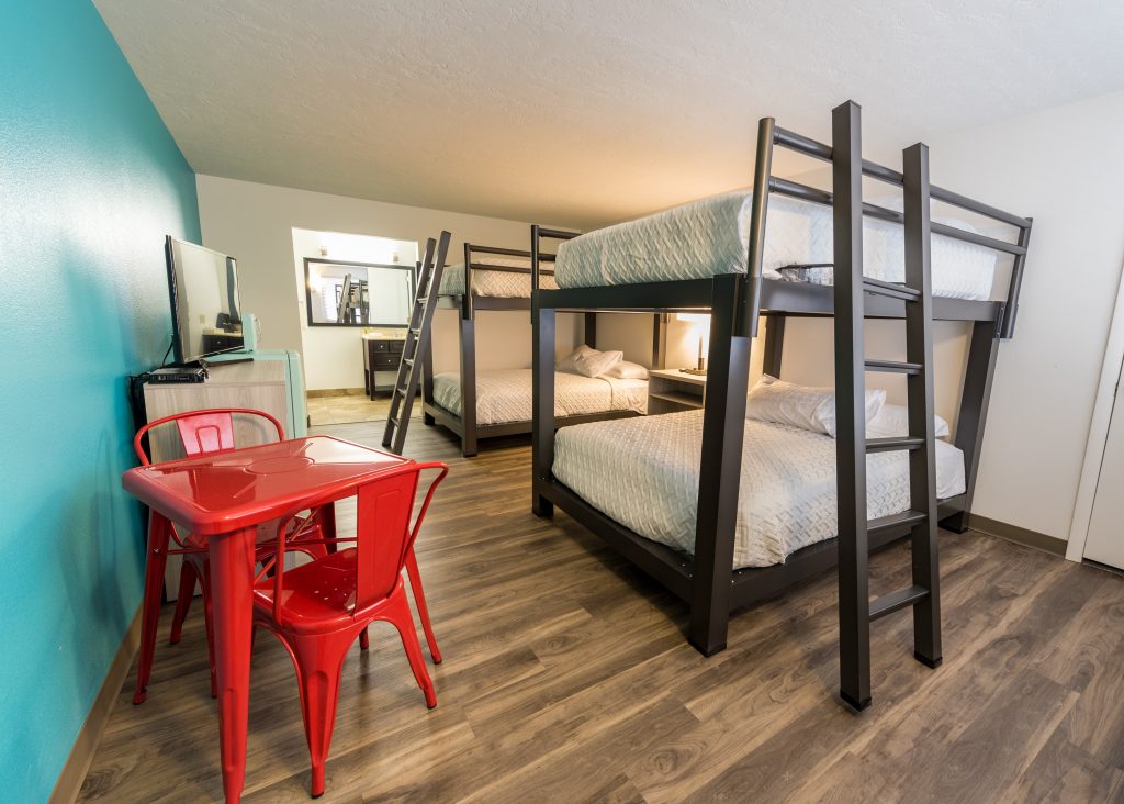 Voyager Room at Expedition Lodge Moab with two sets of Queen-sized bunk beds, accommodating up to 8 guests, ideal for families and groups near Arches National Park.