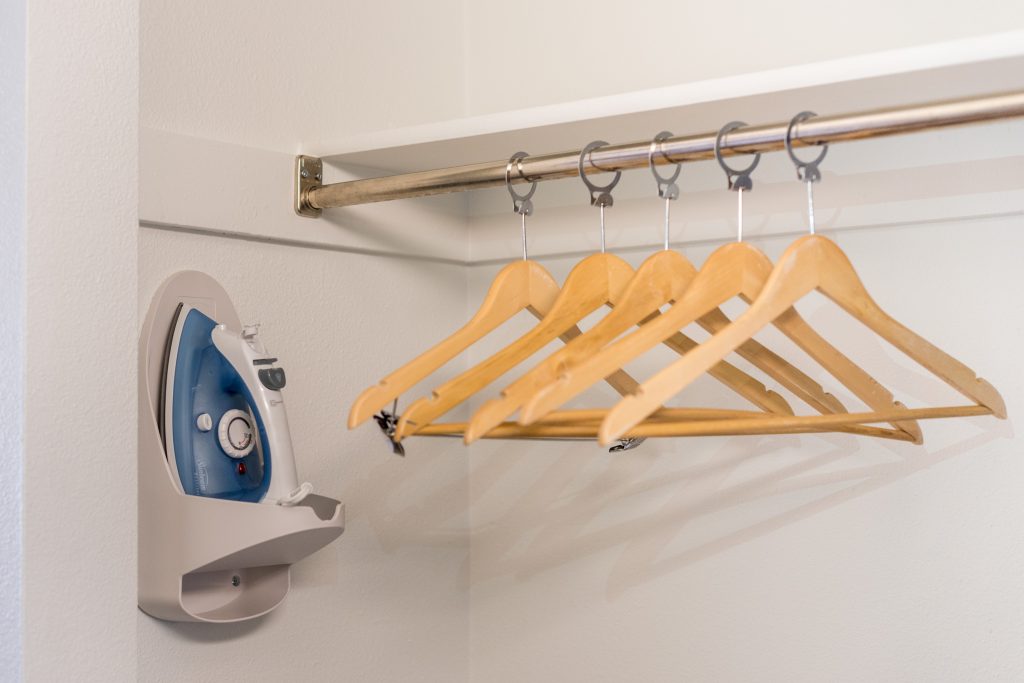 In-room closet at Expedition Lodge Moab with hangers and iron, showcasing convenient amenities for guests near Arches National Park.