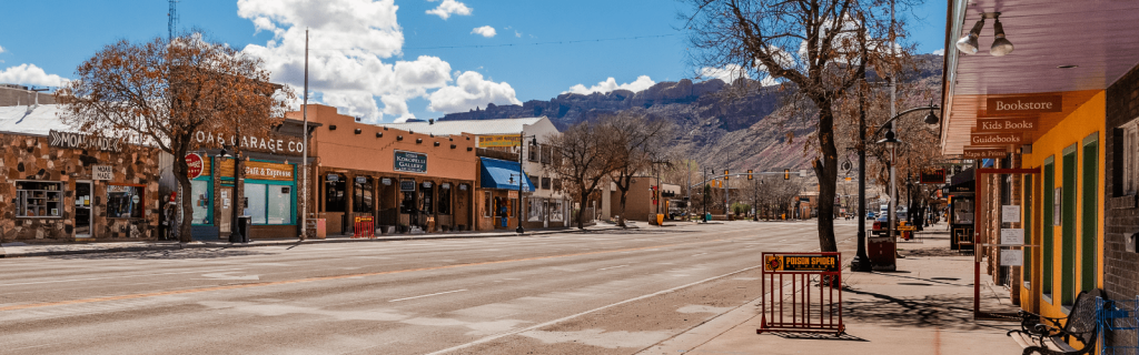 Downtown Moab with local shops, cafes, and a backdrop of red rock formations, a hub for dining and shopping near Arches National Park.